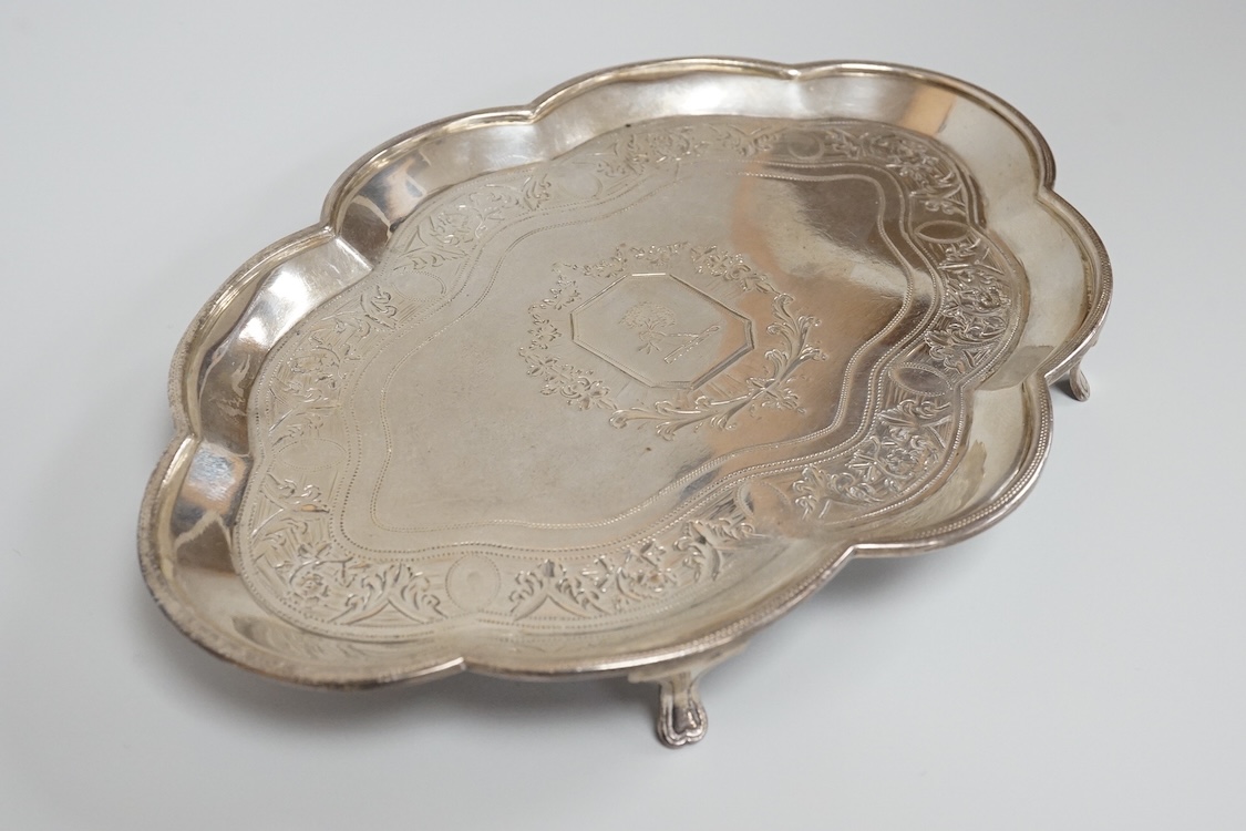 A George III silver cusped oval teapot stand, by Charles Aldridge, London, 1792, with engraved crest and foliate band, on four cabriole feet, London, 1792, 18.8cm, 5oz.